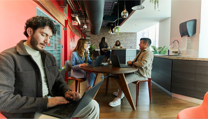 Colgate-Palmolive team collaborating in modern office meeting space.